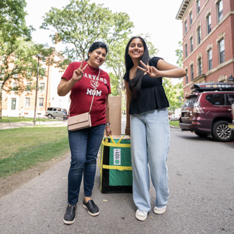 two people standing with packages behind them