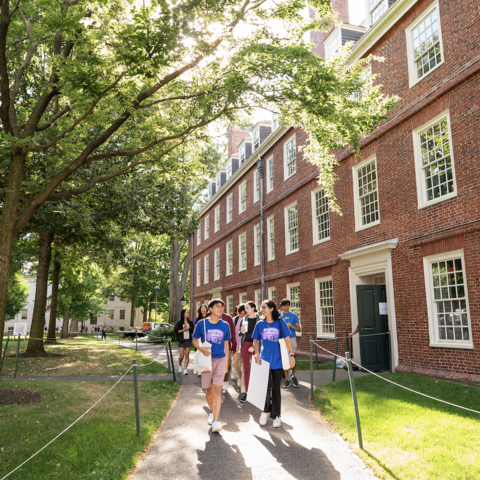 a group of people walking in front of a brick building