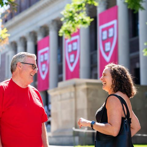 Dean of Students, Thomas Dunne, talks to a parent on Move-In Day 2025 in front of Widener Library
